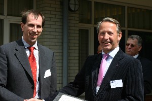 At the June meeting, Huub Simons, chief, Consultation, Command and Control Agency (NC3A) (l), receives a certificate of appreciation from Cdre. Schoonderbeek.